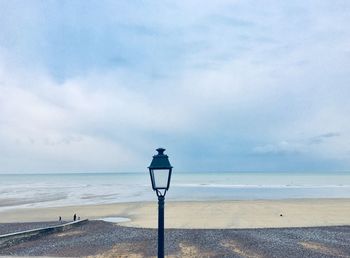 Scenic view of sea with street light  