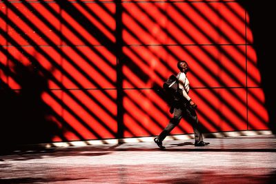 Shadow of man on red wall