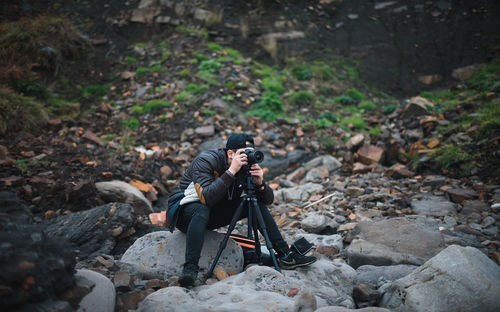 Male photographer on stones