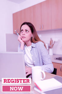 Portrait of a young woman using mobile phone