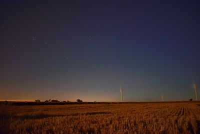 Scenic view of field against clear sky at night