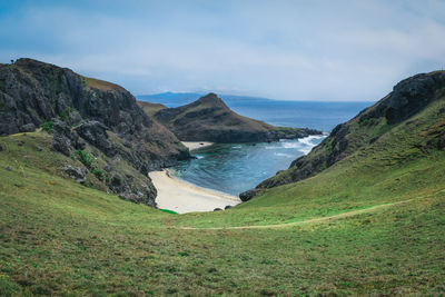 Scenic view of sea and mountains against sky