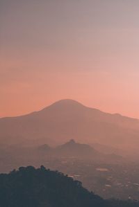 Scenic view of silhouette mountains against sky during sunset