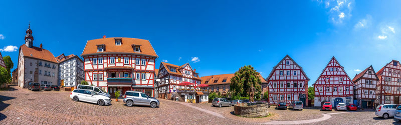 Panoramic shot of buildings against blue sky