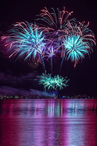 Fireworks over the water of a large lake