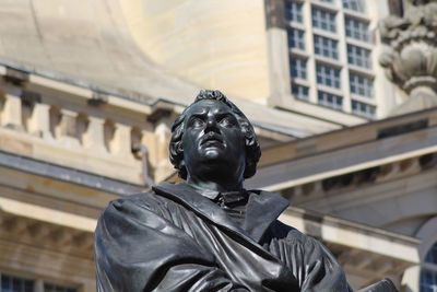 Low angle view of statue against building