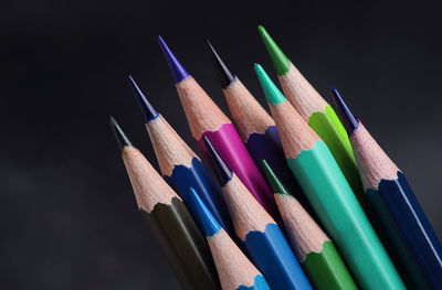 Close-up of colored pencils against black background