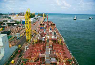 High angle view of cityscape by sea against sky