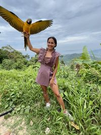 Portrait of woman standing on field