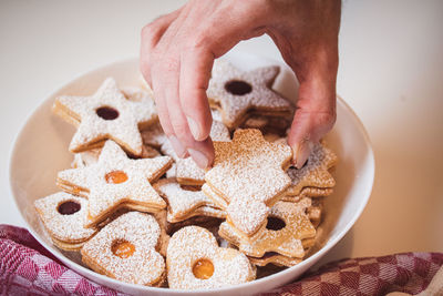 Cropped hand of person preparing food