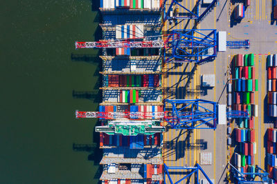 Container ship loading at port with crane, container ship carrying container import and export 