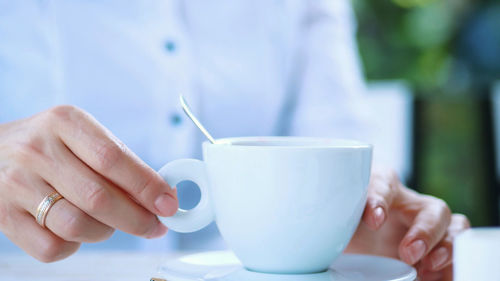 Close-up, white cup with cappuccino, with thick creamy foam and marshmallows