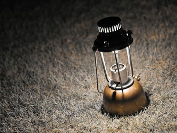 Tilt shot of illuminated electric lamp on grass at night