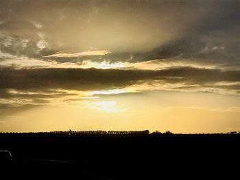 Silhouette landscape against sky during sunset