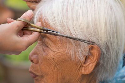 Close-up of hands cutting hair