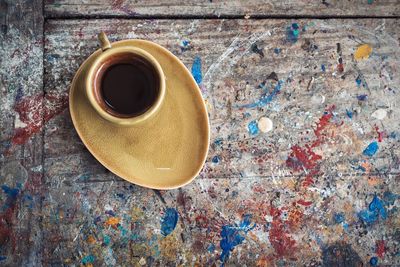 High angle view of black coffee on messy table