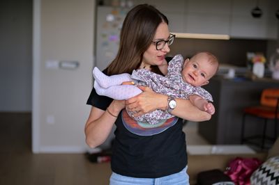 Mother playing with cute little baby girl