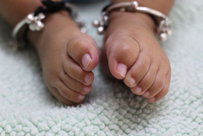 Close-up of baby feet on bed