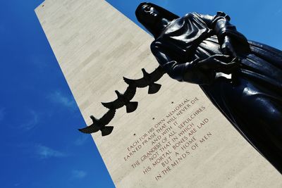 Low angle view of sculpture against sky