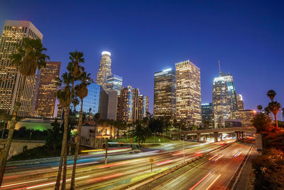 High angle view of illuminated cityscape against clear sky at night