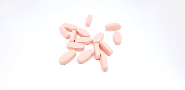 High angle view of pills on white background