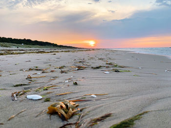 Scenic view of beach against sky during sunset