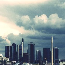 Buildings against cloudy sky