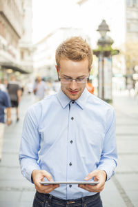 Young man standing in city