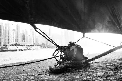 Close-up of rope against buildings in city