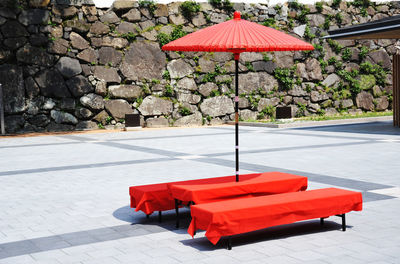 Red umbrella on footpath