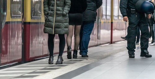 Low section of people walking on railway bridge