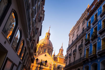 Unusual prospective from below of the basilica de nuestra señora de pilar illuminated by sunlight