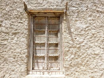Low angle view of closed window of old building