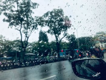 Road seen through wet glass window