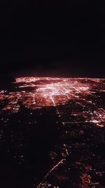 Aerial view of illuminated city against sky at night