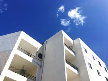 Low angle view of modern building against blue sky