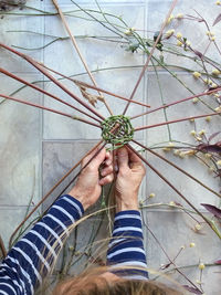 High angle view of of person making basket with nature