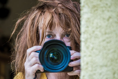 Portrait of woman with messy hair photographing outdoors