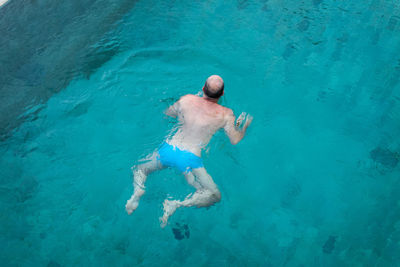 High angle view of man swimming in sea