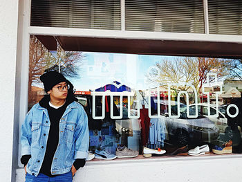 Full length of woman standing against built structure