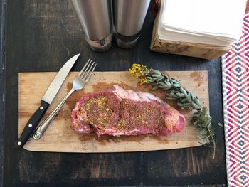 High angle view of meat on cutting board