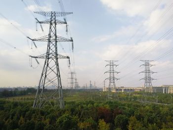 Low angle view of electricity pylon against sky