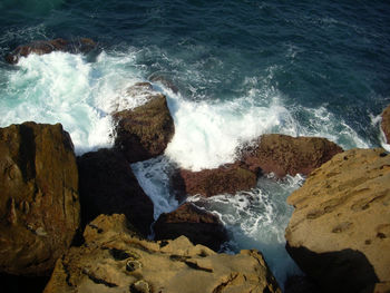 Waves splashing on rocks at beach