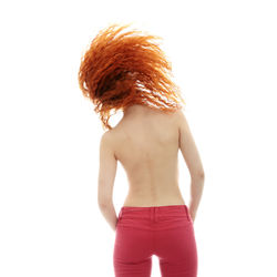 Rear view of woman standing against white background