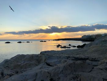 Scenic view of sea against sky at sunset