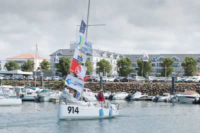 Sailboats in sea against sky