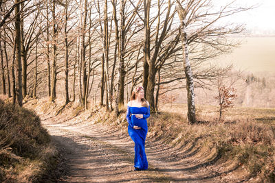 Portrait of man walking on footpath