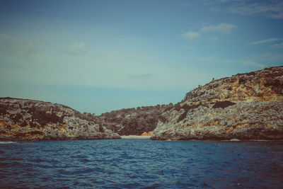 Scenic view of sea and mountains against sky