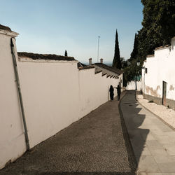 People walking on road against sky