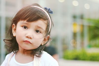 Close-up portrait of cute girl looking away